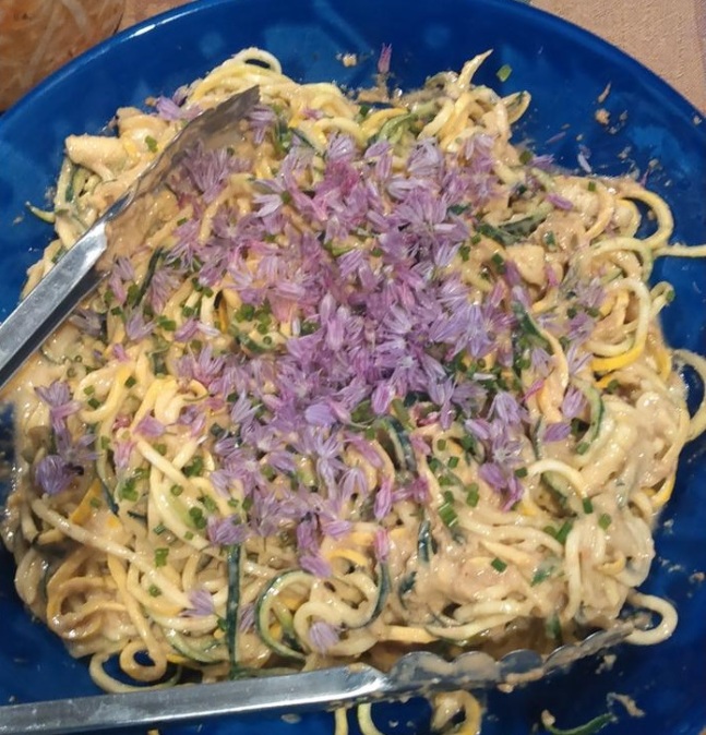 Zoodles with peanut sauce and chive blossoms